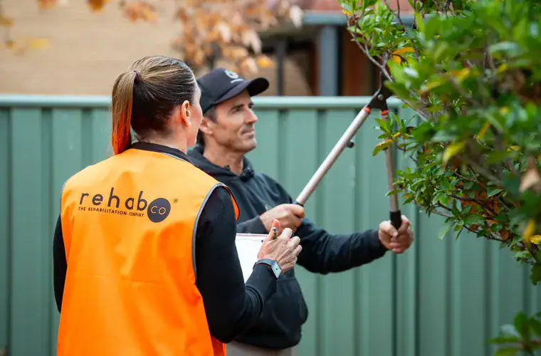 A Rehab Co consultant with a worker in high-visibility clothing at a worksite