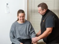 Rehab Co clinician examining a worker’s shoulder during early intervention