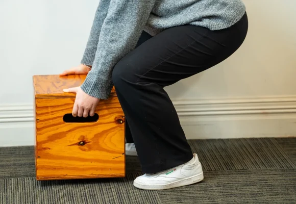 Demonstration of safe lifting technique using a wooden lifting box