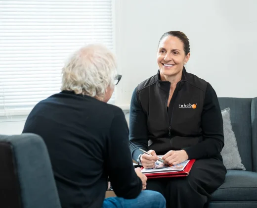 Rehab Co employment specialist providing person-centred support in a seated consultation